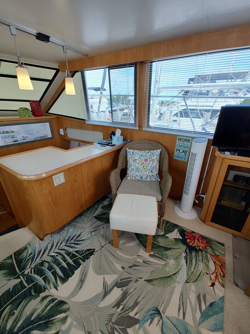 Slide: The Image of Interior of a 1989 Chris-Craft Catalina with a cozy seating area and large windows. - 14