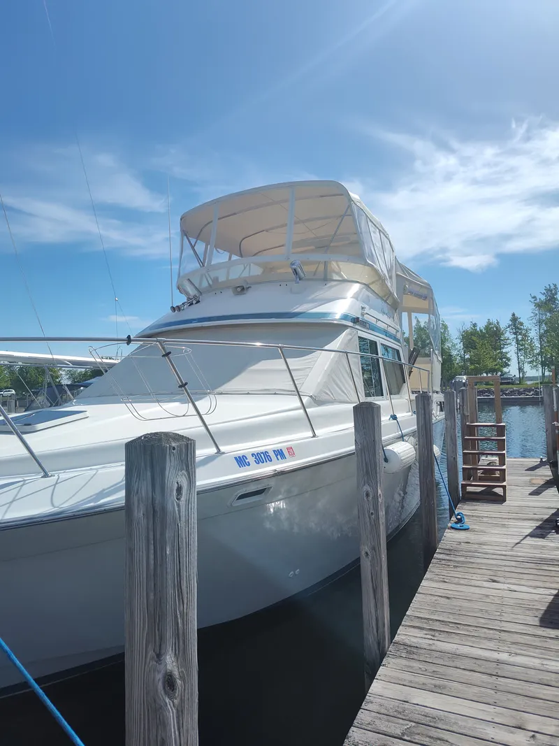 The Image of 1989 Chris-Craft Catalina at dock with covered upper deck. - 0