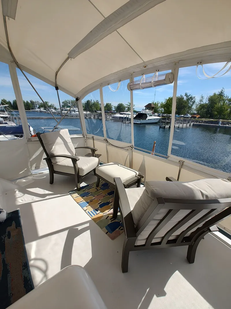 Slide: The Image of The image shows a boat's covered seating area with two chairs and a table. - 3