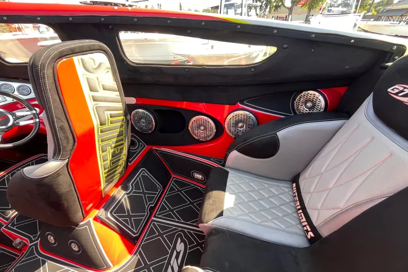 Slide: The Image of Interior of a 2007 Outerlimits 39 GTX boat with stylish seating and audio system. - 13