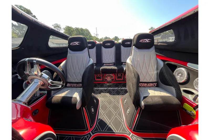 Slide: The Image of Interior of a 2007 Outerlimits 39 GTX boat with stylish seating and steering wheel. - 12