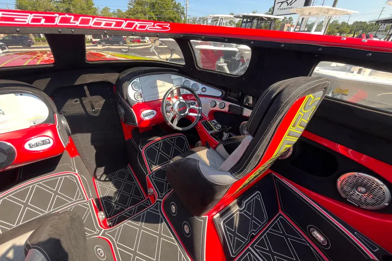 Slide: The Image of Interior of a 2007 Outerlimits 39 GTX boat with red and black design. - 14