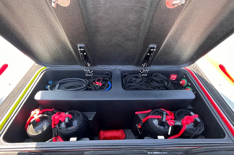 Slide: The Image of Storage compartment of a 2007 Outerlimits 39 GTX boat, featuring ropes and equipment. - 17