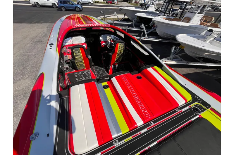 Slide: The Image of 2007 Outerlimits 39 GTX powerboat with vibrant red, yellow, and white interior design. - 10