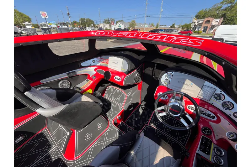 Slide: The Image of Interior of a 2007 Outerlimits 39 GTX boat with modern dashboard and controls. - 15