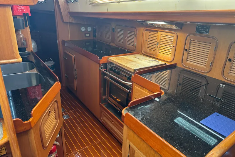Slide: The Image of Luxurious wooden yacht kitchen interior with modern appliances, Mason 54, 1989 model. - 16