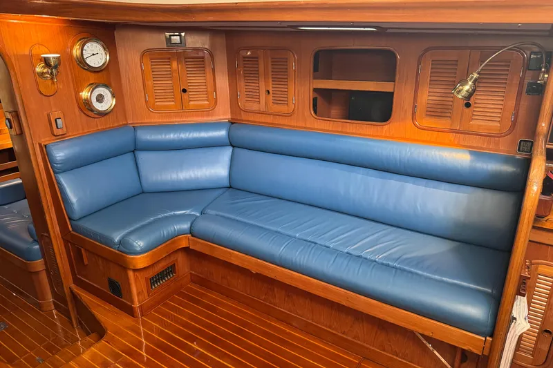 Slide: The Image of Luxurious 1989 Mason 54 yacht interior with blue leather seating and wooden accents. - 23
