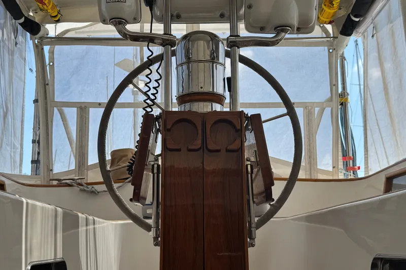 Slide: The Image of Steering wheel of a 1989 Mason 54 yacht, featuring wooden and metal elements. - 37