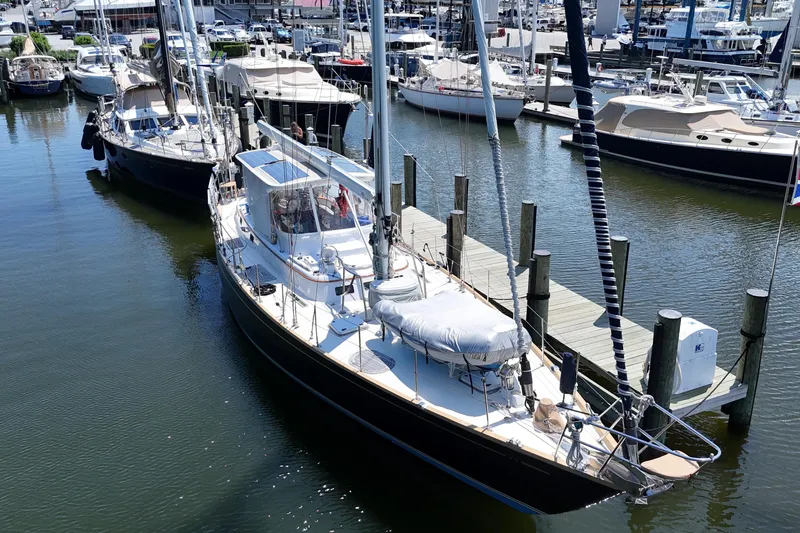 Slide: The Image of Sailboat docked at marina, Mason 54 model, 1989, surrounded by other boats. - 62