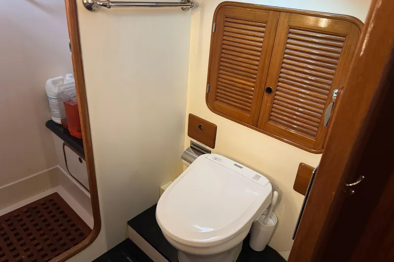 Slide: The Image of Compact bathroom in 1989 Mason 54 yacht with modern toilet and wooden accents. - 35