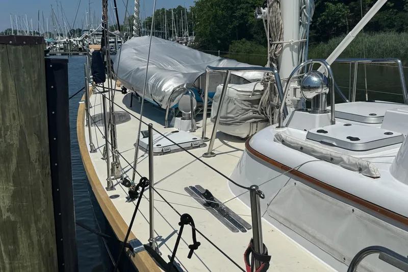 Slide: The Image of Sailboat docked at marina, Mason 54 model, 1989, with covered deck and rigging. - 44