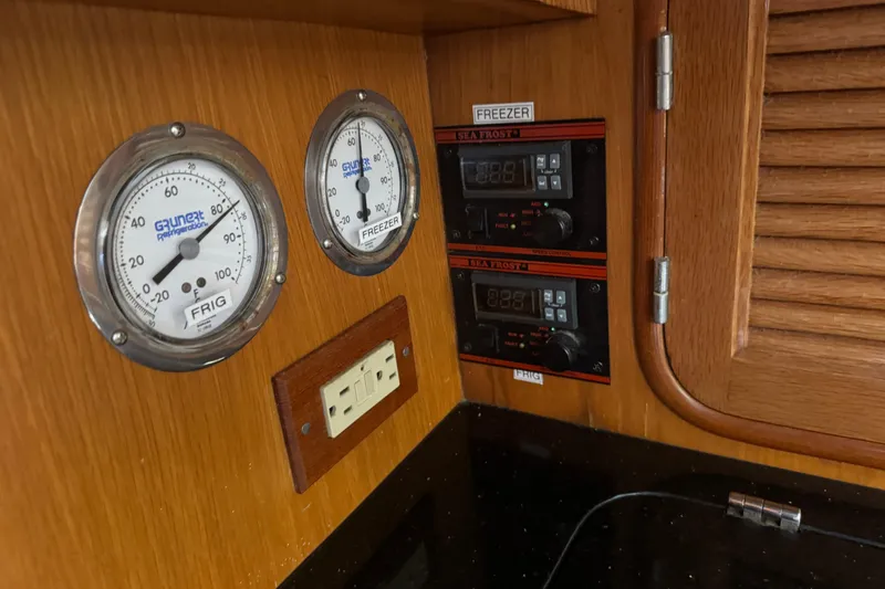 Slide: The Image of Wooden panel with refrigeration gauges and controls on a 1989 Mason 54 yacht. - 20