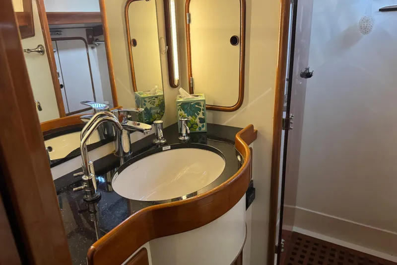 Slide: The Image of Elegant bathroom in 1989 Mason 54 yacht with modern sink and wooden accents. - 34