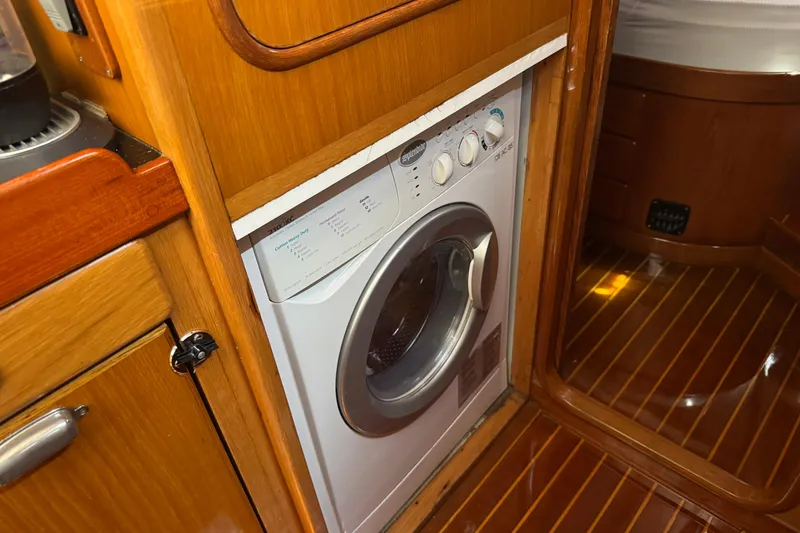 Slide: The Image of Compact washing machine in wooden cabinet on 1989 Mason 54 yacht interior. - 22