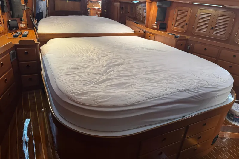 Slide: The Image of Luxurious cabin interior of a 1989 Mason 54 yacht with a spacious bed and wooden furnishings. - 30