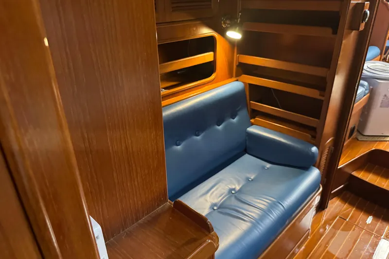 Slide: The Image of Interior of 1989 Mason 54 yacht with blue leather seating and wooden finish. - 8