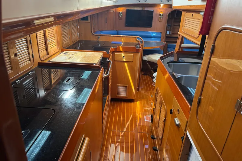 Slide: The Image of Luxurious 1989 Mason 54 yacht interior with polished wood and modern amenities. - 15