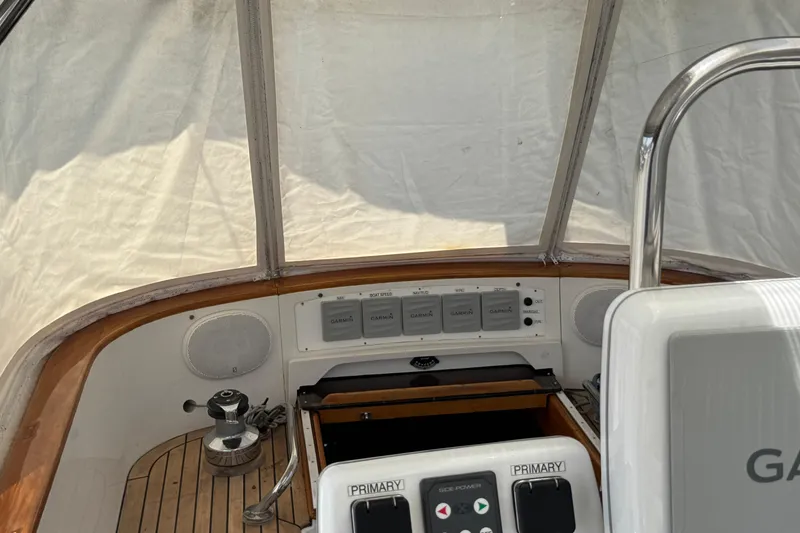 Slide: The Image of Cockpit of 1989 Mason 54 sailboat with navigation controls and wooden trim. - 39