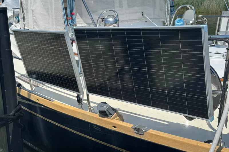 Slide: The Image of Solar panels mounted on a 1989 Mason 54 sailboat, harnessing renewable energy. - 57