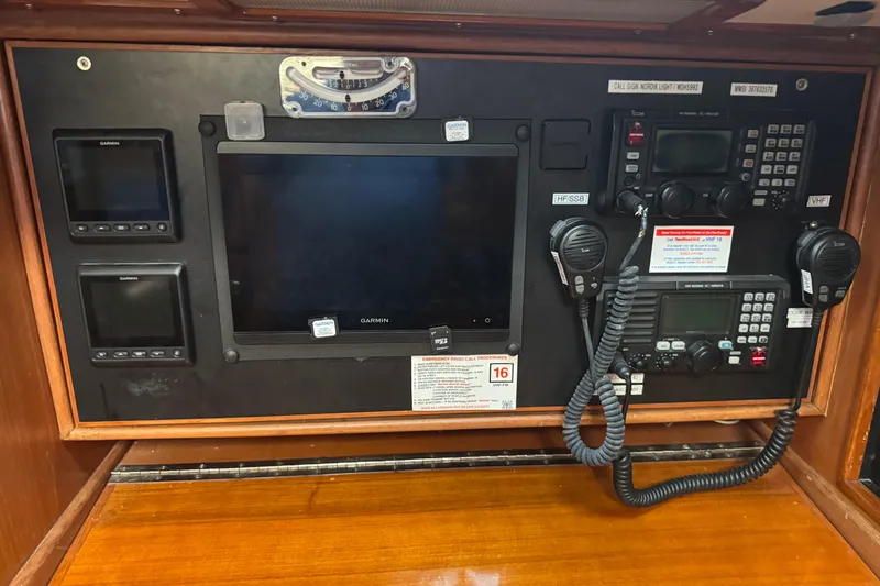 Slide: The Image of Navigation and communication panel on a 1989 Mason 54 yacht, featuring Garmin displays and radios. - 25