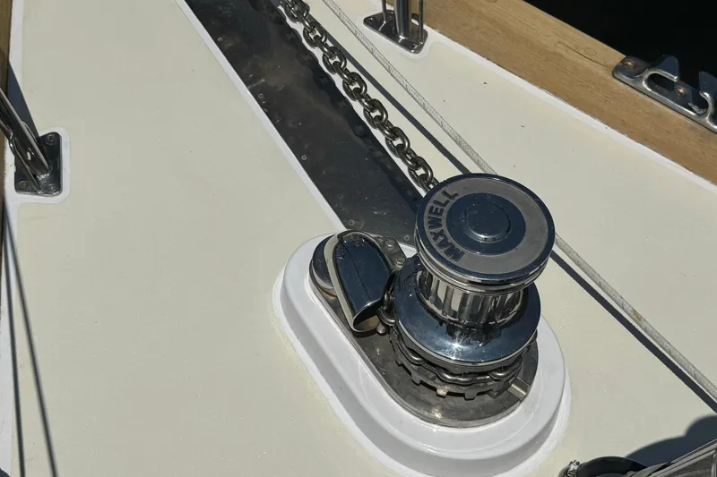 Slide: The Image of Anchor windlass on 1989 Mason 54 yacht deck, featuring Maxwell branding. - 46