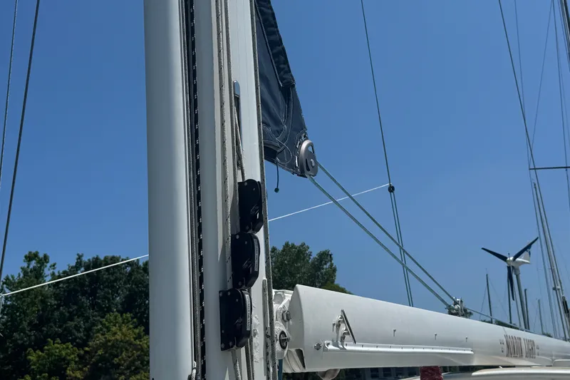 Slide: The Image of Close-up of a 1989 Mason 54 sailboat mast and rigging against a clear blue sky. - 52