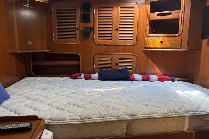 Slide: The Image of Cozy cabin interior of 1989 Mason 54 yacht with wooden paneling and comfortable bedding. - 6