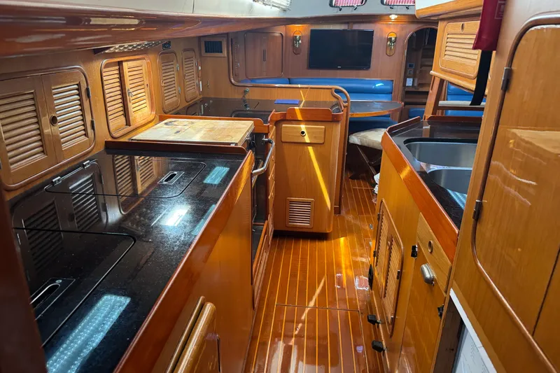 Slide: The Image of Luxurious 1989 Mason 54 yacht interior with wooden cabinetry and modern amenities. - 2