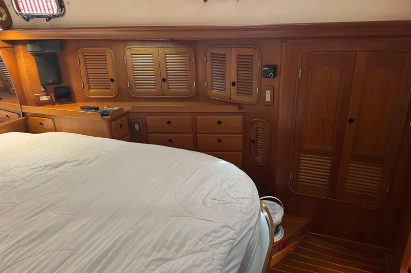 Slide: The Image of Cozy cabin interior of 1989 Mason 54 yacht with wooden cabinetry and bed. - 31