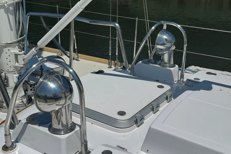 Slide: The Image of Deck of 1989 Mason 54 yacht with polished metal fixtures and hatch. - 48