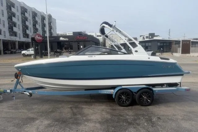 Slide: The Image of 2026 Cobalt R4 boat on trailer, parked in urban area with modern buildings. - 5