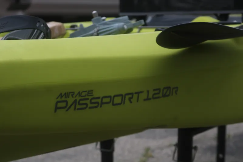 Slide: The Image of 2025 Hobie Mirage Passport 12.0 R kayak in vibrant green with paddle. - 5