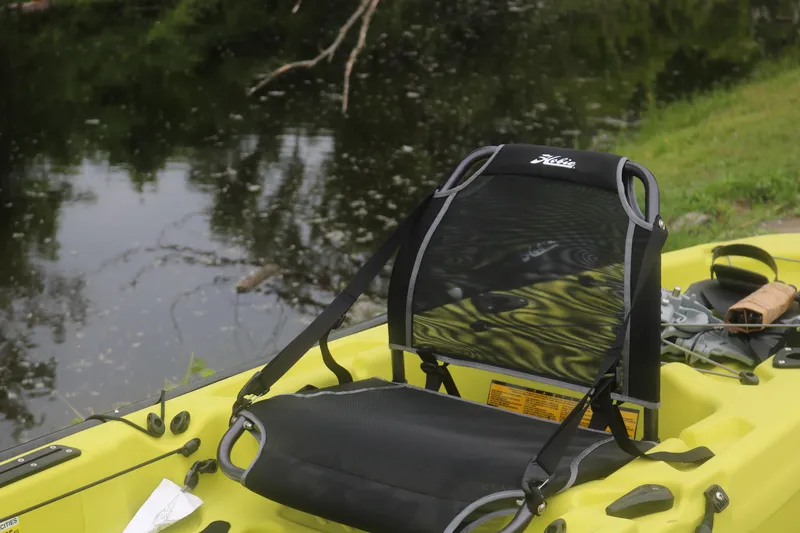 Slide: The Image of Yellow Hobie Mirage Passport 12.0 R kayak seat by a calm river, 2025 model. - 3