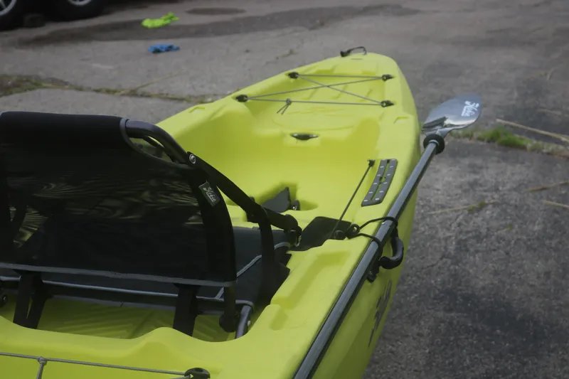 Slide: The Image of Yellow Hobie Mirage Passport 12.0 R kayak, 2025 model, with paddle on pavement. - 6