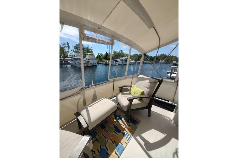 Slide: The Image of 1989 Chris-Craft 372 Catalina boat interior with comfortable seating and scenic marina view. - 3