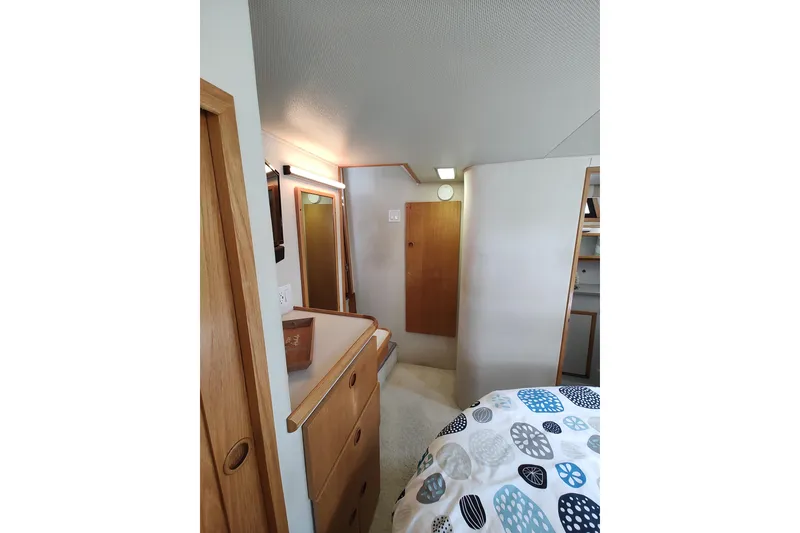 Slide: The Image of Interior of 1989 Chris-Craft 372 Catalina yacht, featuring wooden cabinetry and cozy decor. - 21