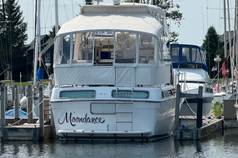 Slide: The Image of 1989 Chris-Craft 372 Catalina yacht named "Moondance" docked at a marina. - 33