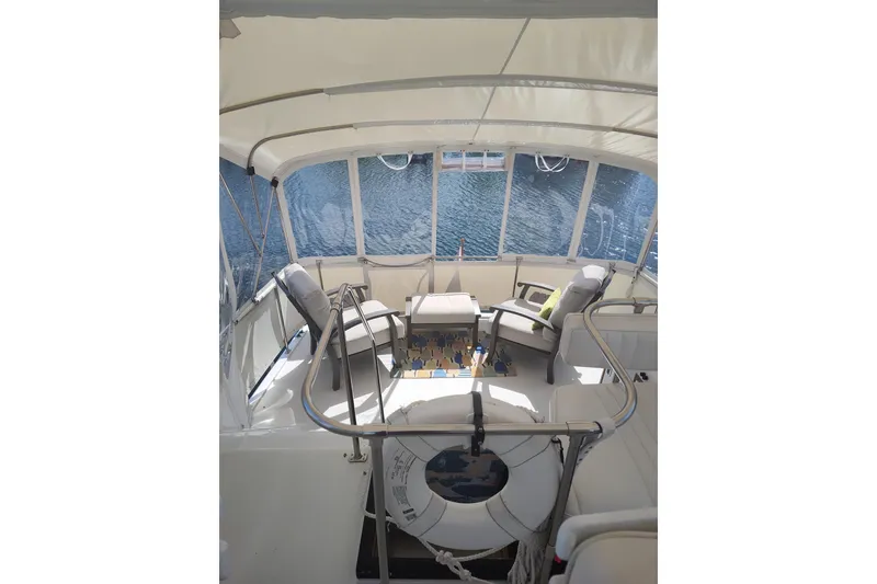 Slide: The Image of 1989 Chris-Craft 372 Catalina yacht interior with seating, table, and water view. - 5