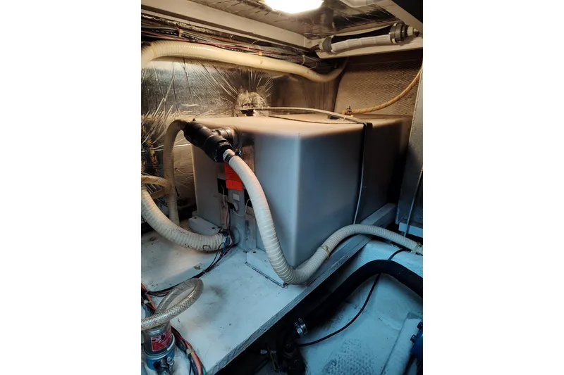 Slide: The Image of Engine room of 1989 Chris-Craft 372 Catalina with visible hoses and equipment. - 25