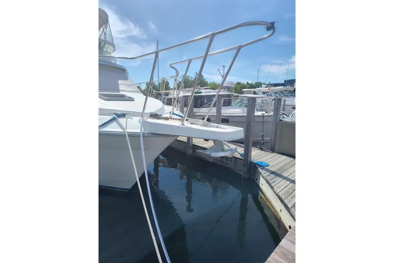 Slide: The Image of 1989 Chris-Craft 372 Catalina yacht docked at marina under clear blue sky. - 1
