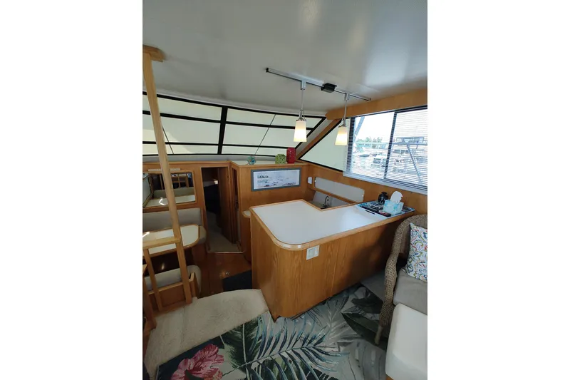 Slide: The Image of Interior of 1989 Chris-Craft 372 Catalina yacht with wood accents and modern amenities. - 7