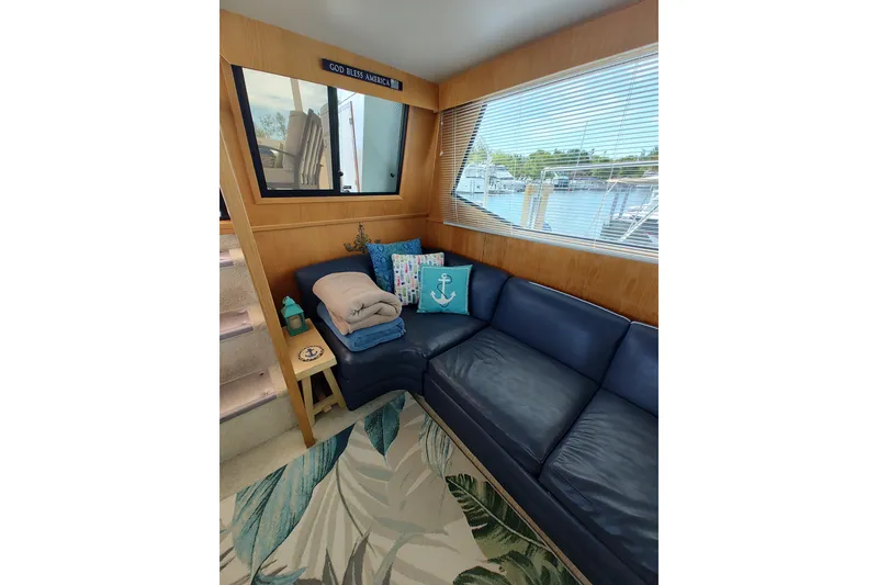 Slide: The Image of Cozy interior of 1989 Chris-Craft 372 Catalina yacht with blue seating and nautical decor. - 10