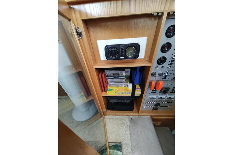 Slide: The Image of 1989 Chris-Craft 372 Catalina interior with radio, books, and control panel. - 30
