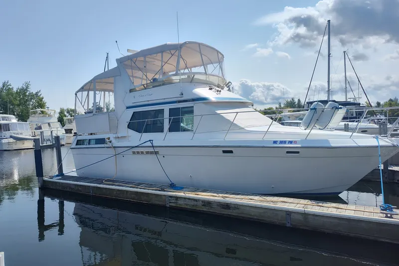 Slide: The Image of 1989 Chris-Craft 372 Catalina yacht docked at a marina under a clear sky. - 37