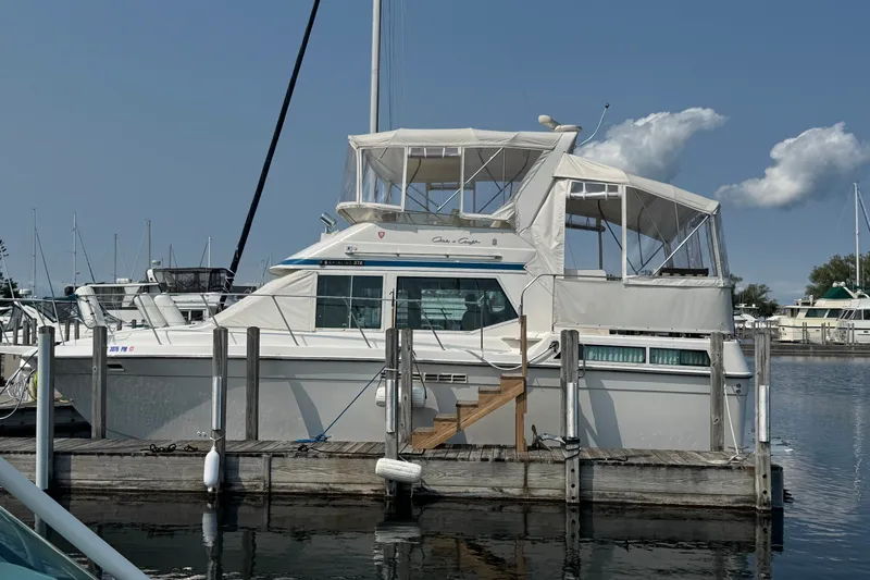 Slide: The Image of 1989 Chris-Craft 372 Catalina yacht docked at marina under clear blue sky. - 1
