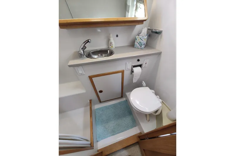 Slide: The Image of 1989 Chris-Craft 372 Catalina bathroom with sink, toilet, and mirror. - 18
