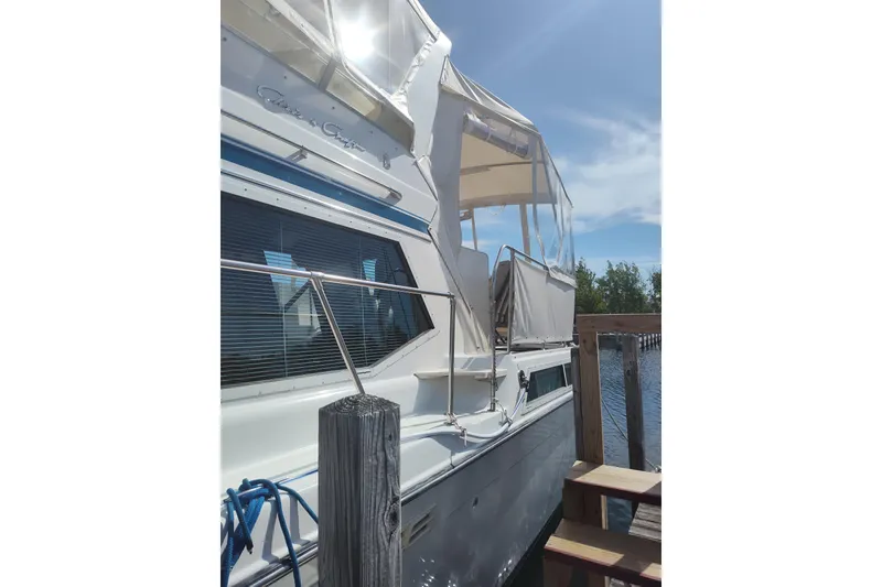Slide: The Image of 1989 Chris-Craft 372 Catalina yacht docked under sunny skies. - 2