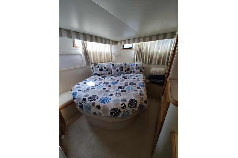 Slide: The Image of Cozy bedroom interior of 1989 Chris-Craft 372 Catalina yacht with patterned bedding. - 19