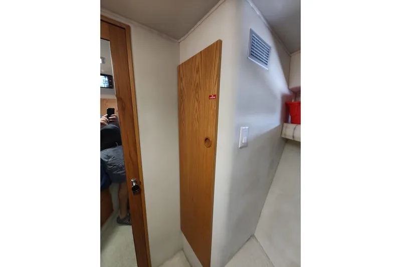 Slide: The Image of Interior of 1989 Chris-Craft 372 Catalina, featuring wooden door and modern fixtures. - 15