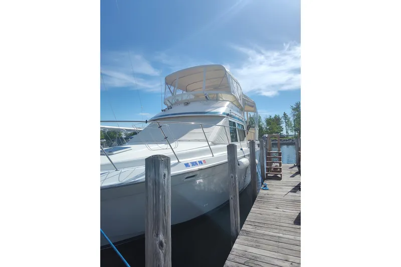 The Image of 1989 Chris-Craft 372 Catalina yacht docked under clear blue sky. - 0